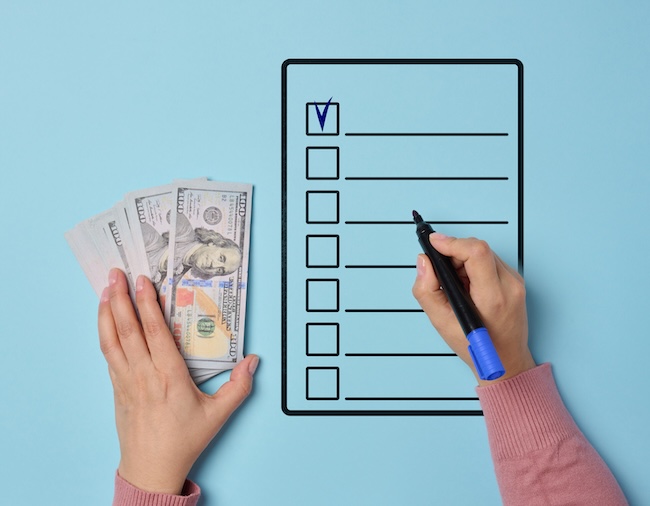 Person filling shopping list composition for budget planning